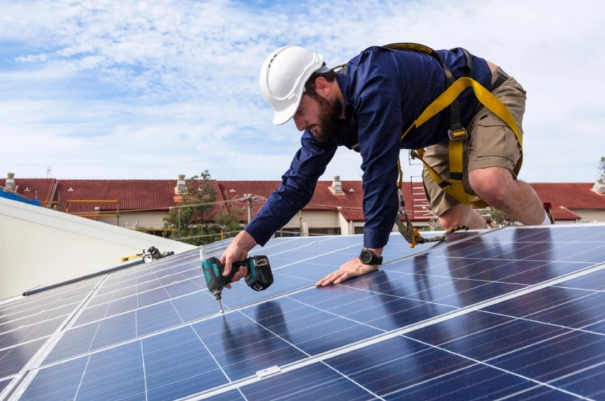 A man working on the roof of a house.