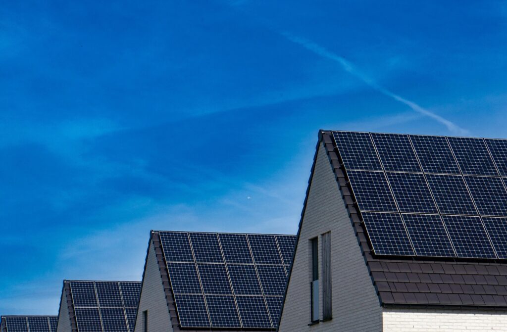 A row of houses with solar panels on the roof.